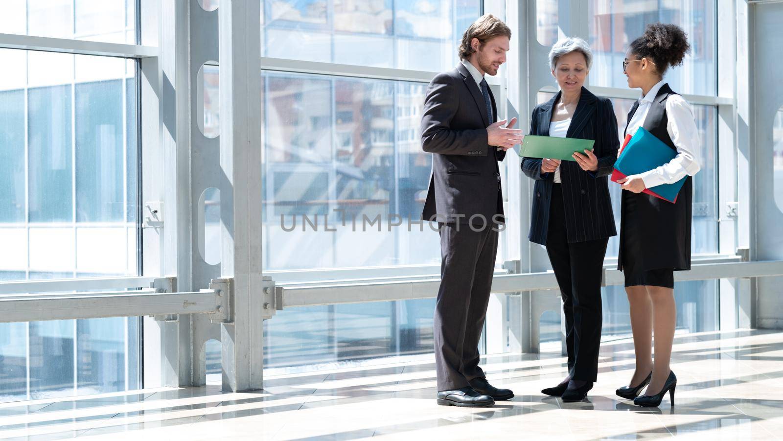 Business people talking about documents by ALotOfPeople