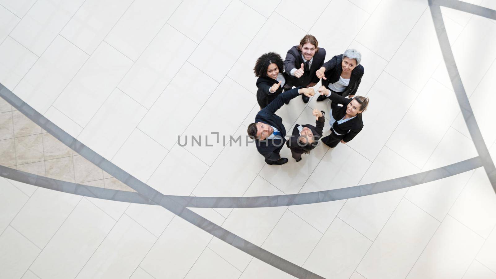 Top view of business people with thumbs up together in a circle