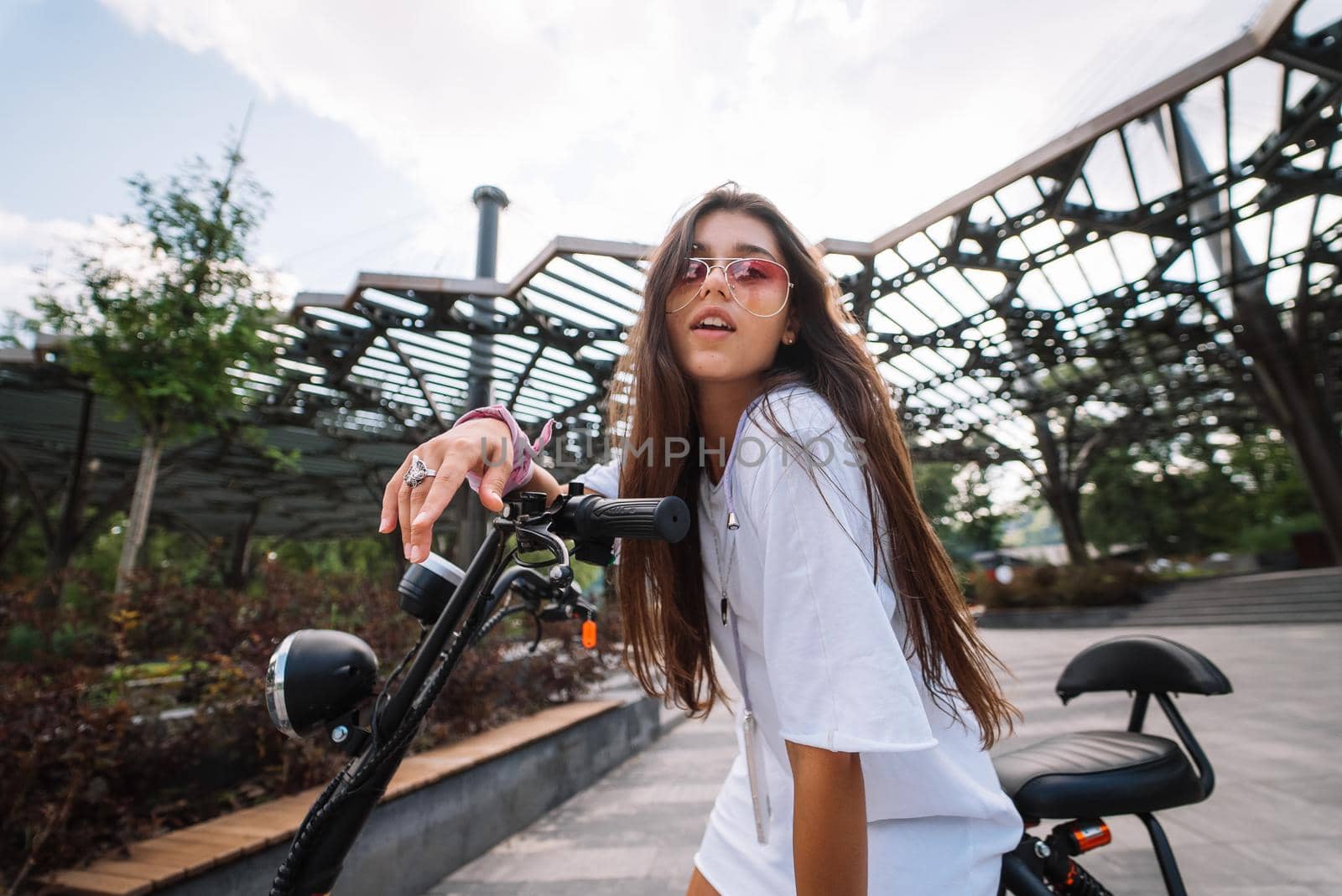 Young beautiful woman and an electric scooter, modern girl, new generation, electric transport, ecological transport