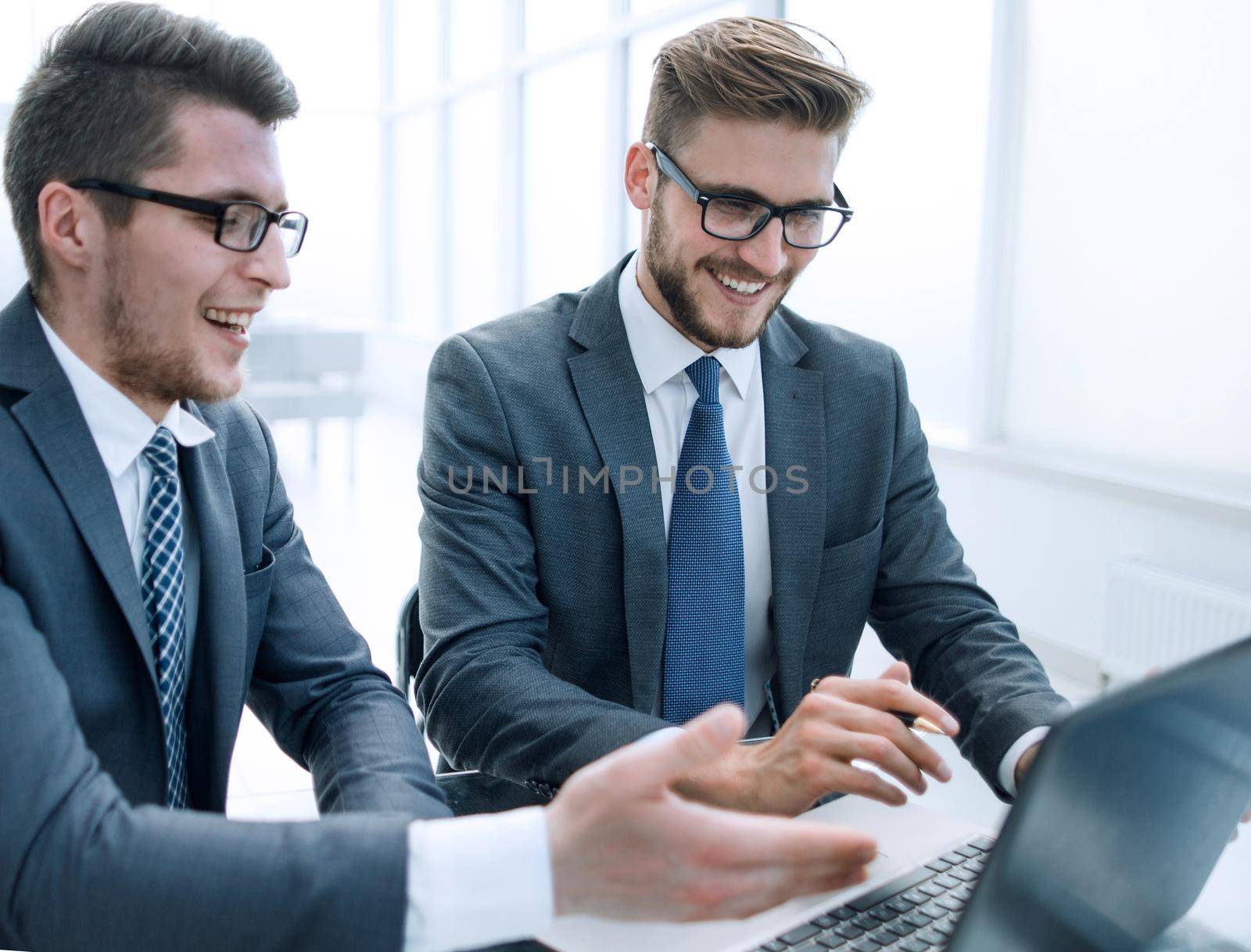 close up.two business people work on a laptop by asdf