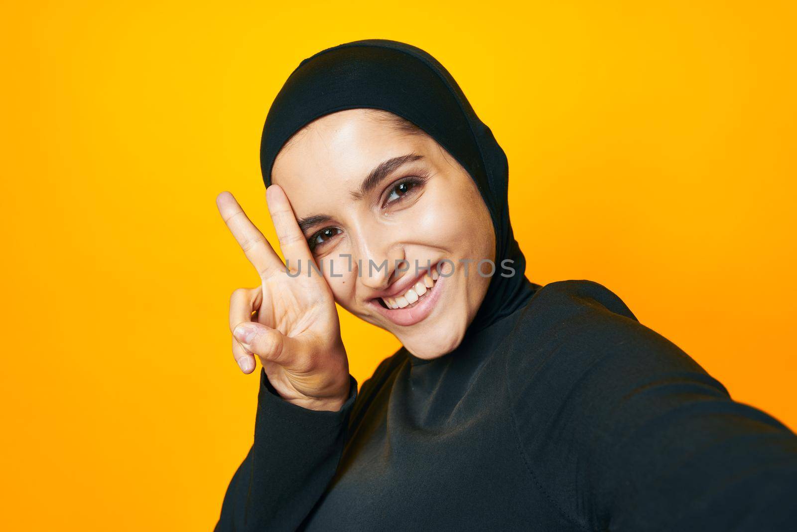 cheerful woman happiness fashion clothing hand gesture yellow background. High quality photo