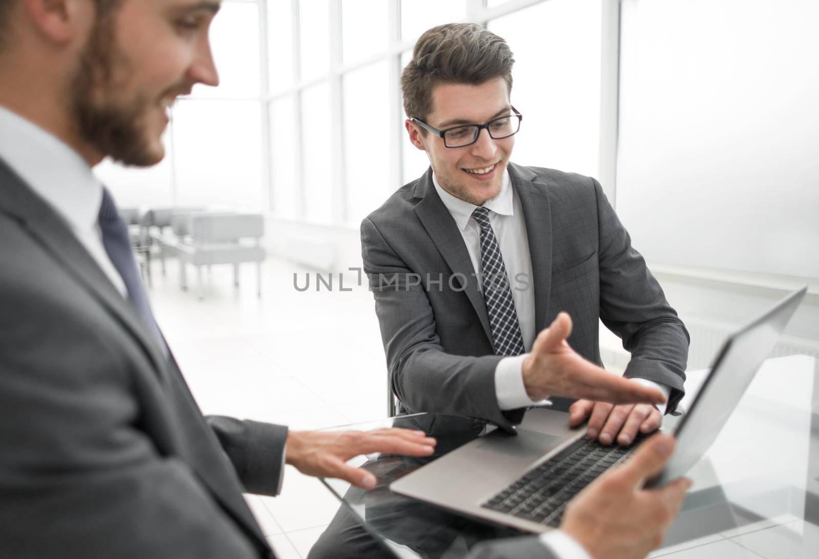 close up.business partners discuss information sitting at the office table by asdf