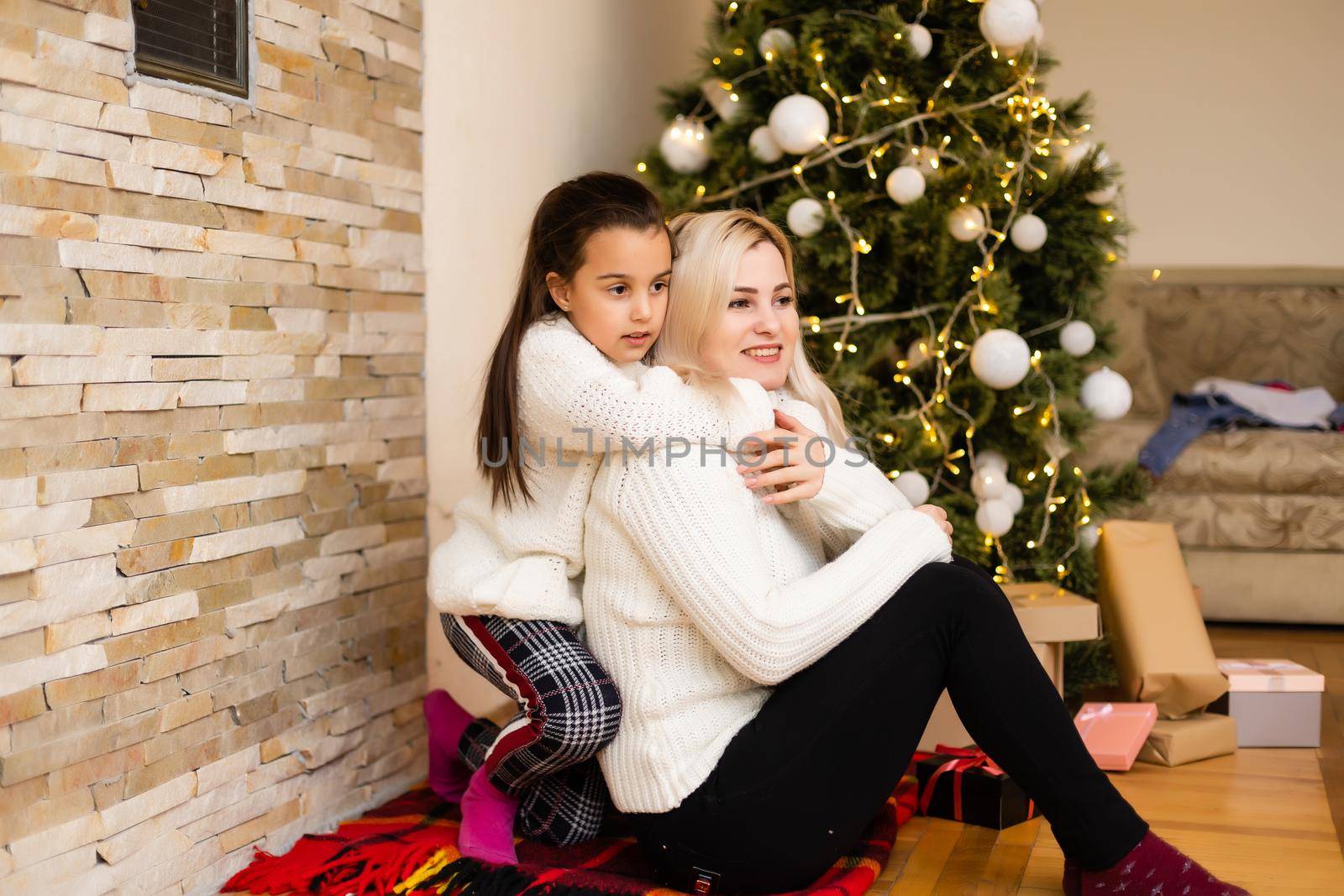 Christmas, happy family mother with daughter with gifts on Xmas Eve