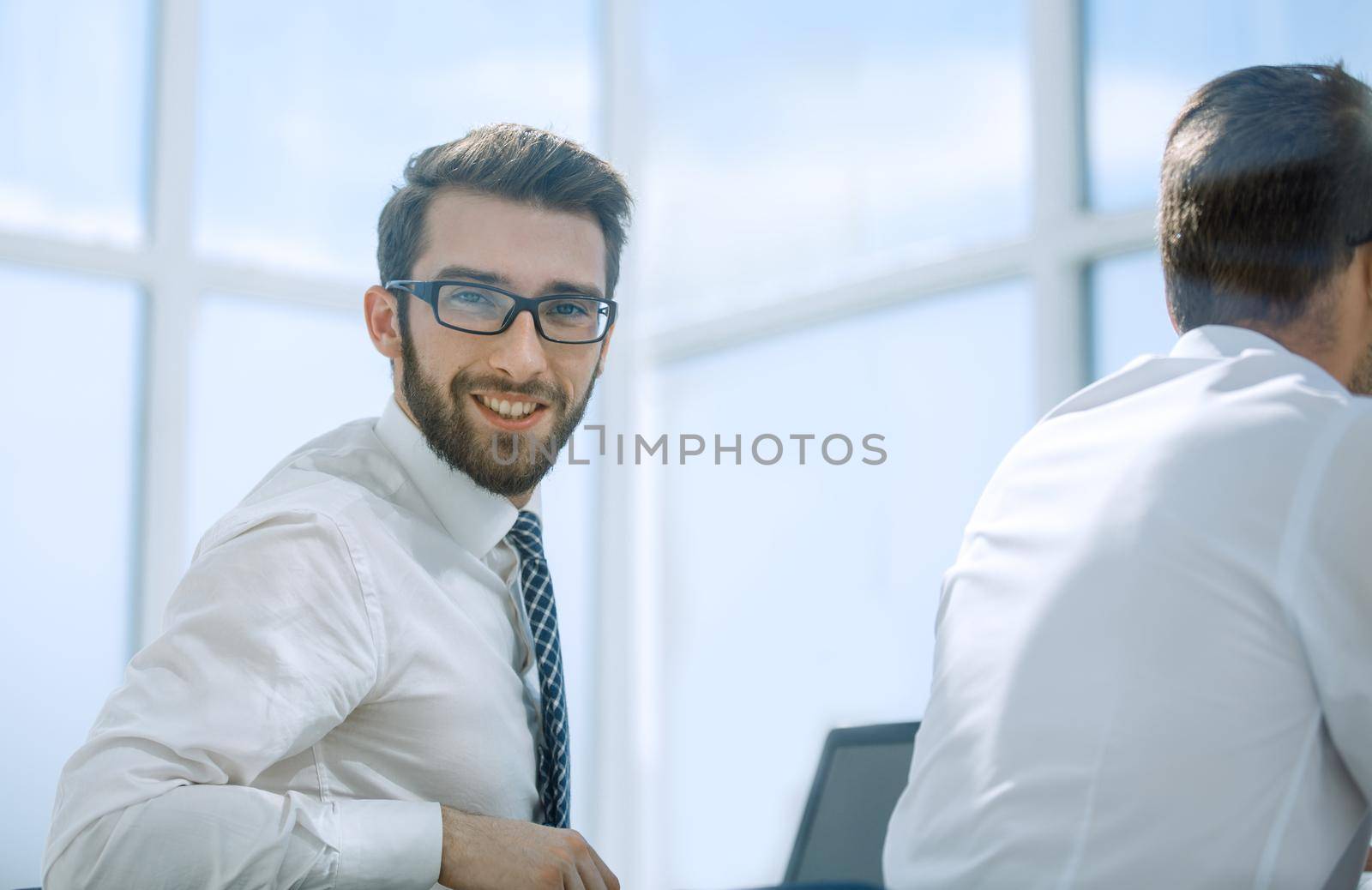 rear view.successful employee looking at the camera.office weekdays