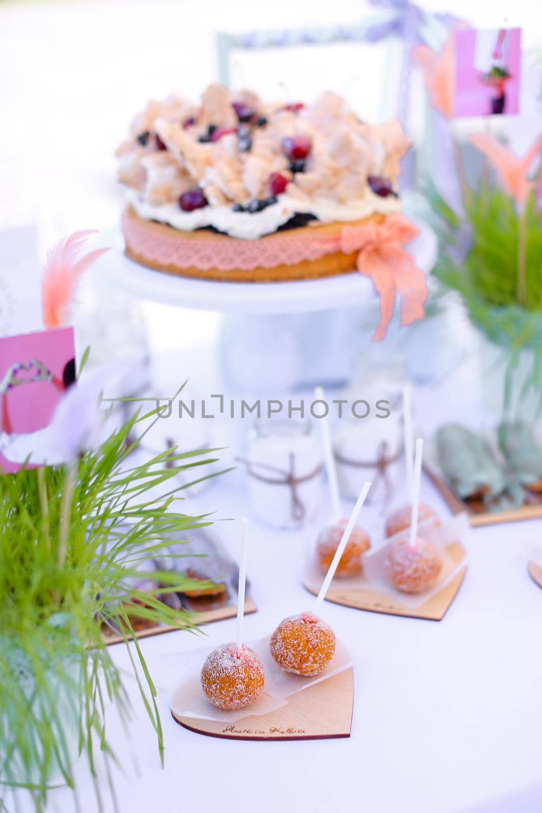 Yummy sweet cakes on white table for birthday party. Concept of sweets and tasty food.