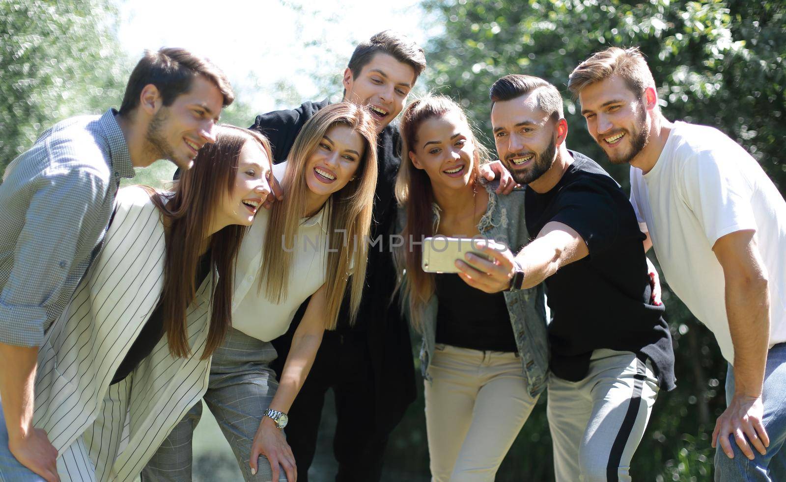 group of friends takes a selfie on the background of the city Park.people and technology