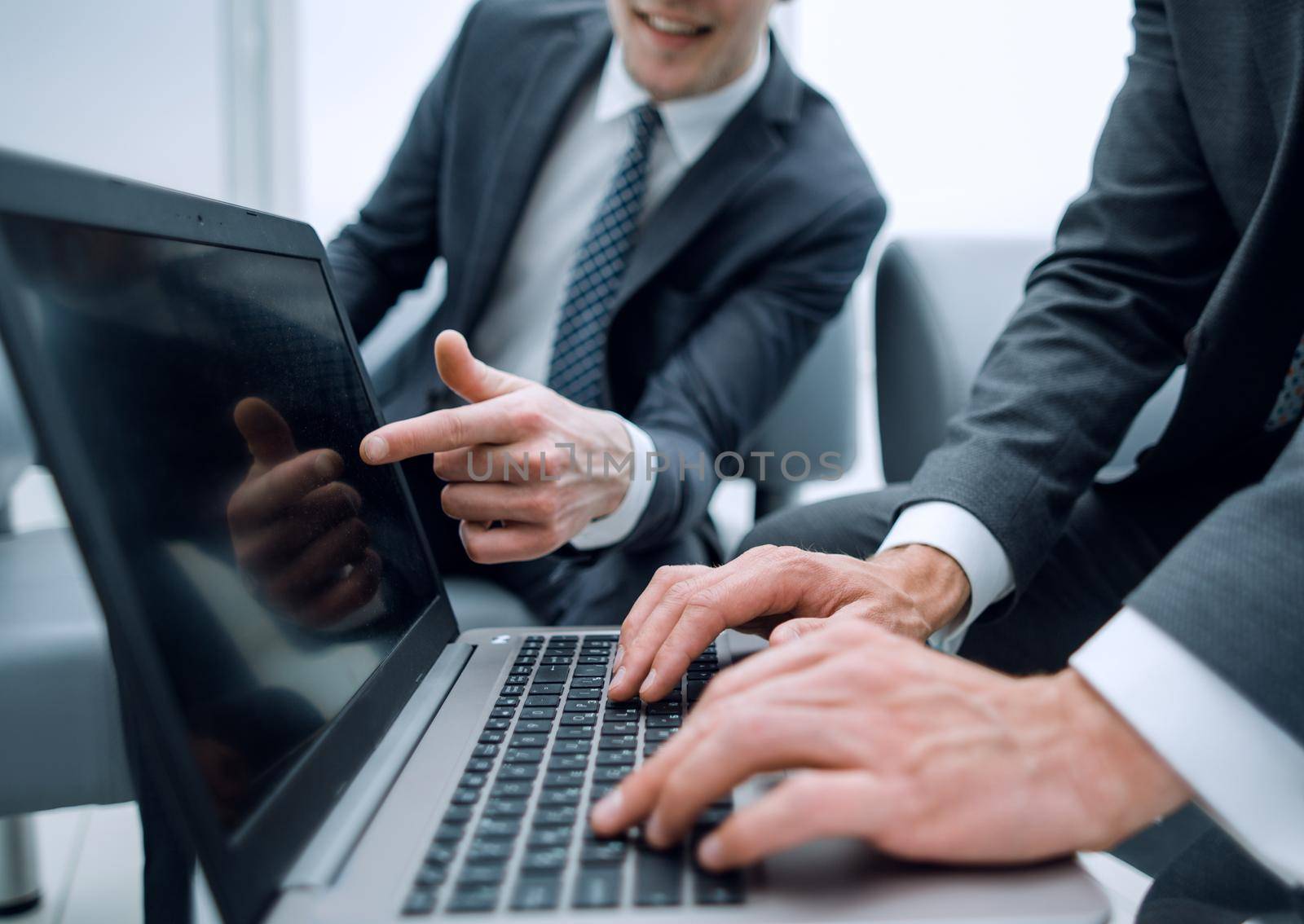 close up.businessman typing document on a laptop by asdf