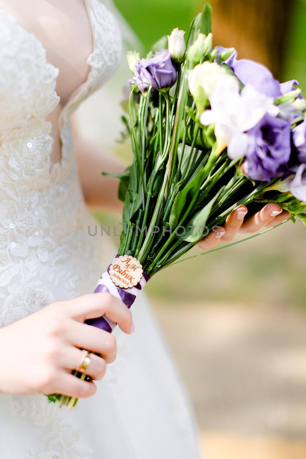 Closeup bridal nice bouquet of violet flowers. Concept of wedding photo session and floristic art.