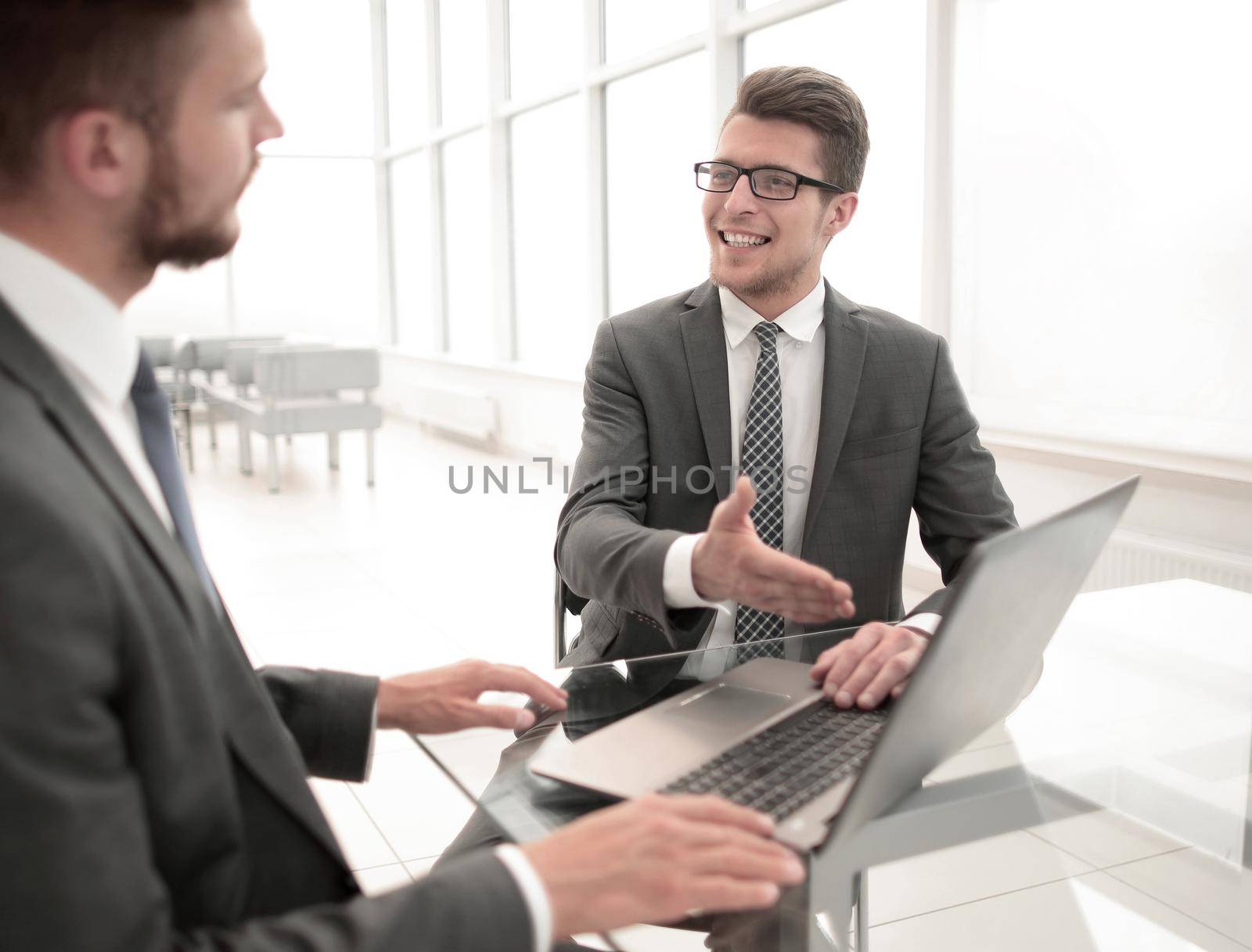 close up.business partners discuss information sitting at the office table by asdf