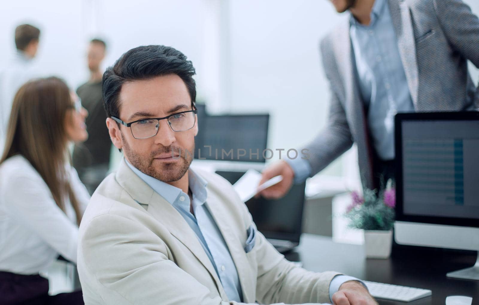 businessman sitting at the office Desk by asdf