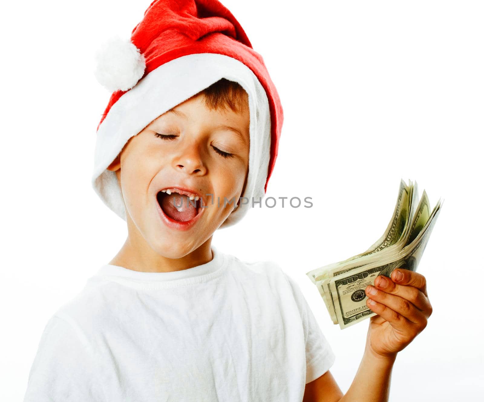 little cute boy in santas red hat isolated with cash american dollars thumbs up closeup