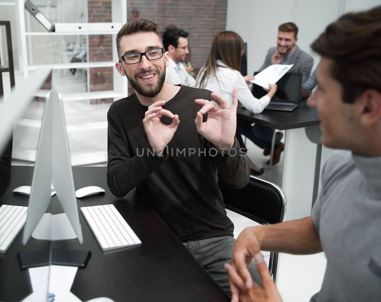 business team is discussing something sitting at the Desk.business concept