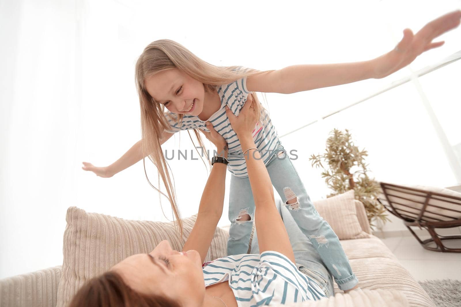 mom plays with her daughter .the concept of family happiness