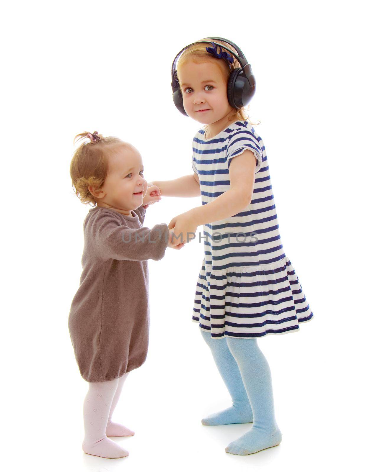 two sisters play fun playing. The concept of family happiness and development of children. Isolated over white background