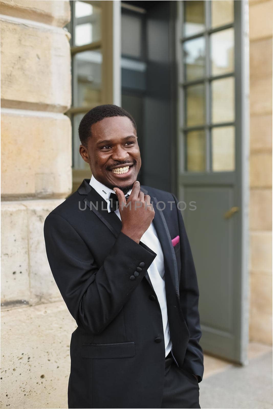 Afro american man wearing suit and standing near building. by sisterspro