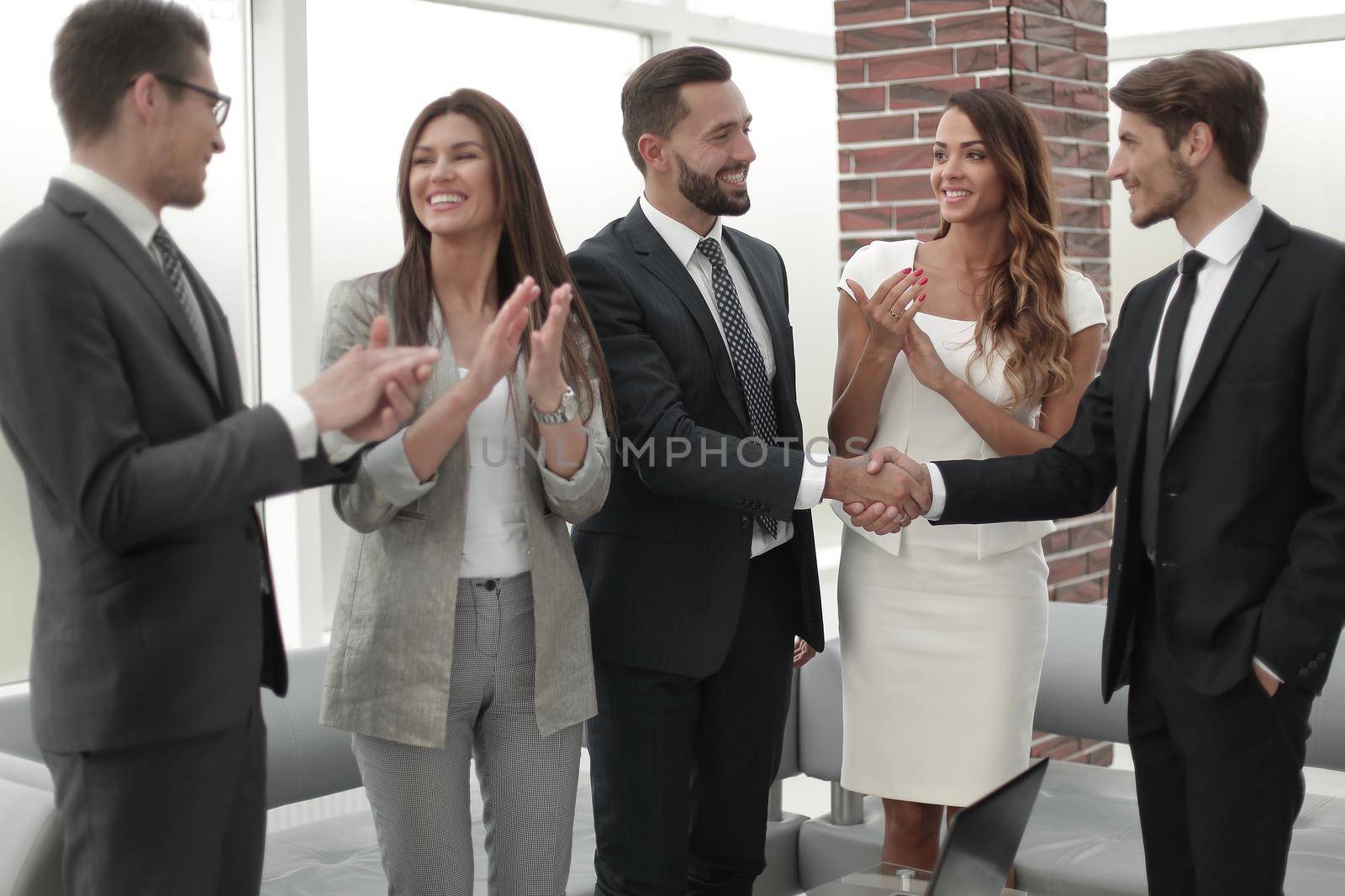 businessmen greet each other with a handshake by asdf