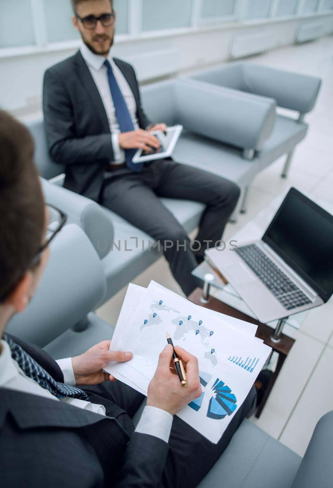 close up.the businessman checks the financial report.business concept