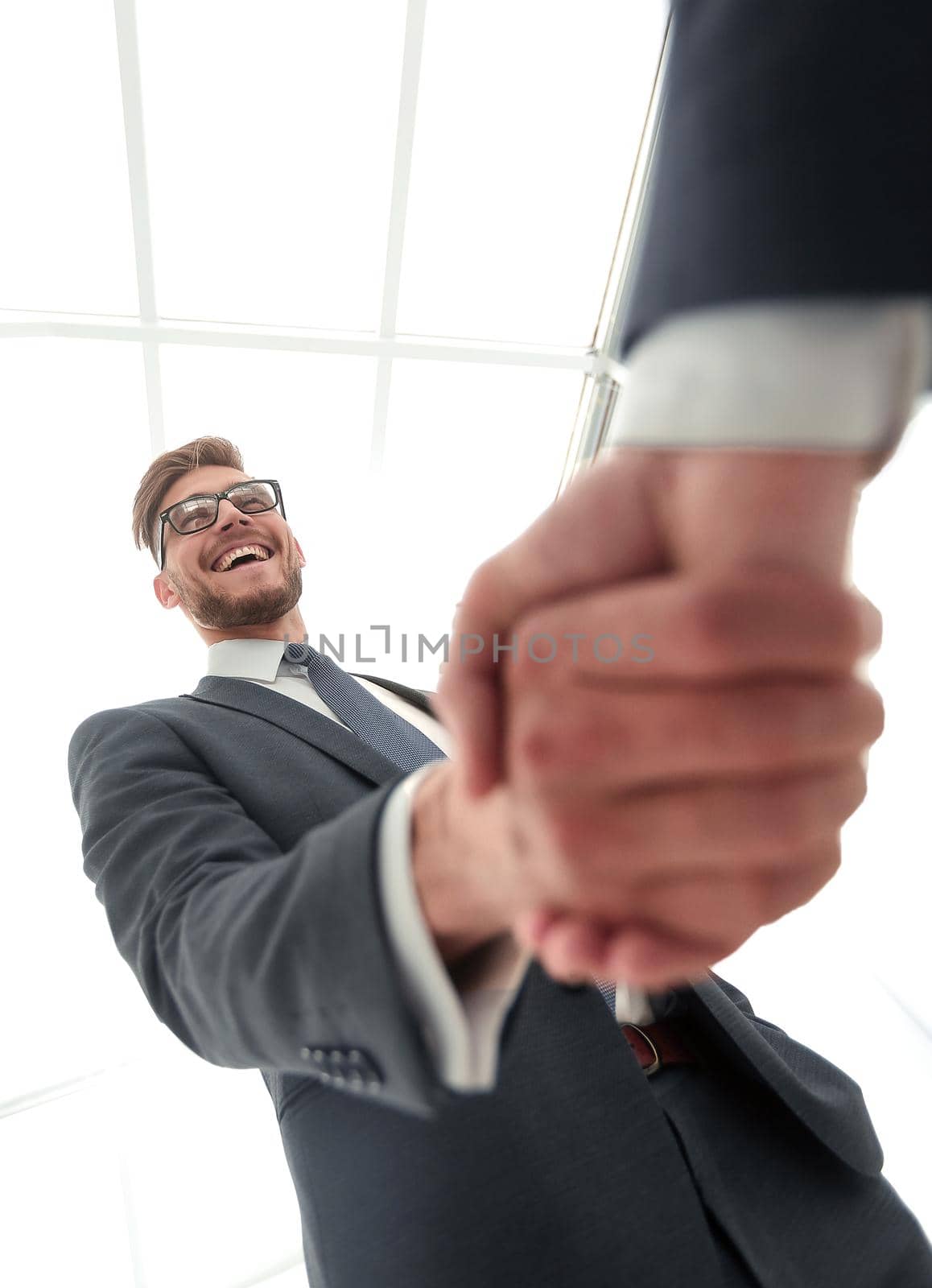 close up.business handshake.isolated on light background