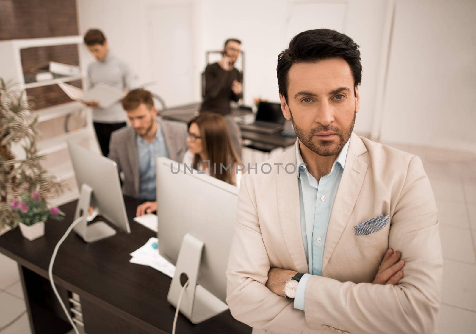 confident businessman in the background of his office.business people