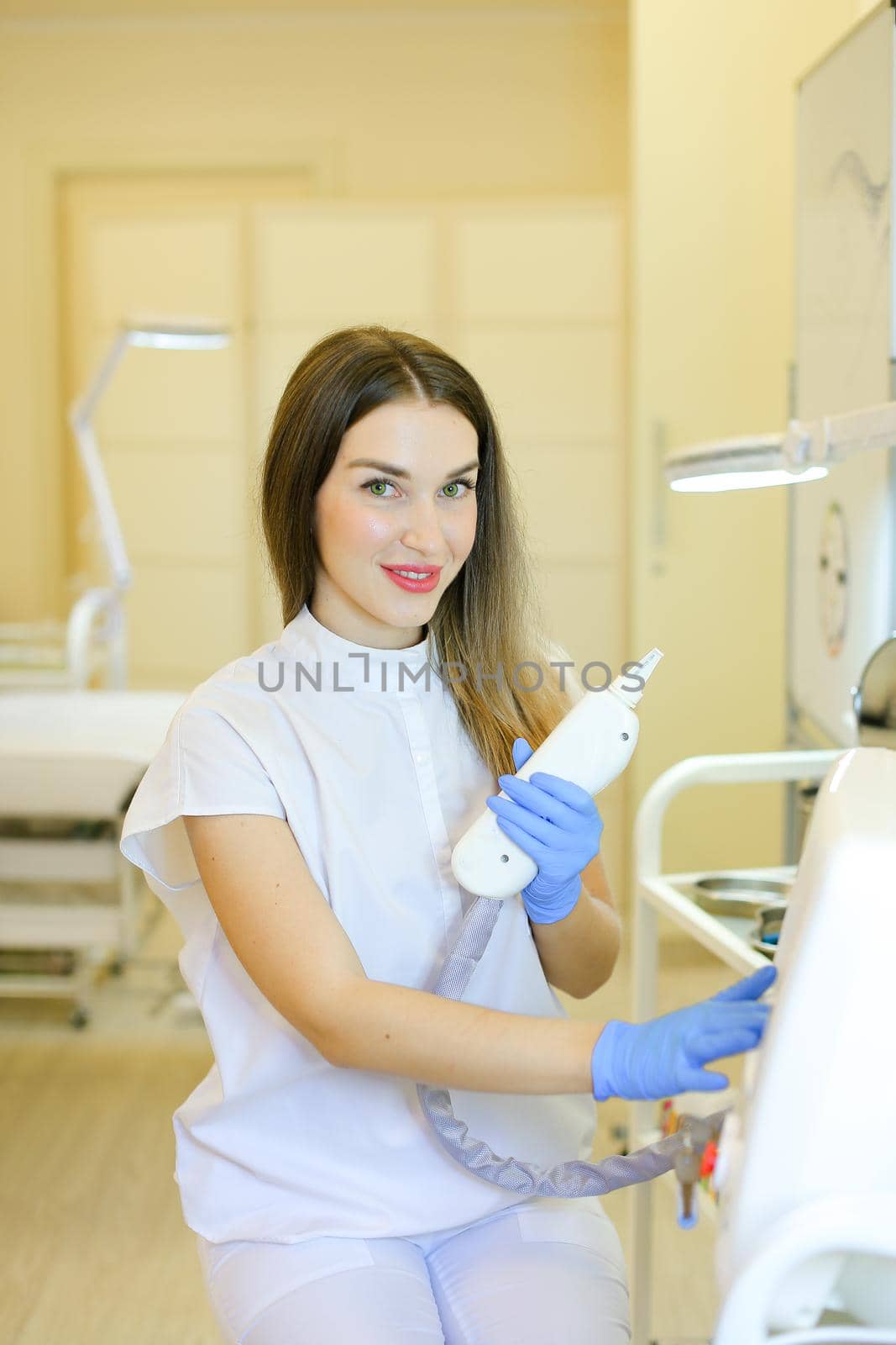 Caucasian permanent makeup artist sitting with laser removal of tatoos device at beauty salon. Concept of cosmetology equipment and cosmetologist.