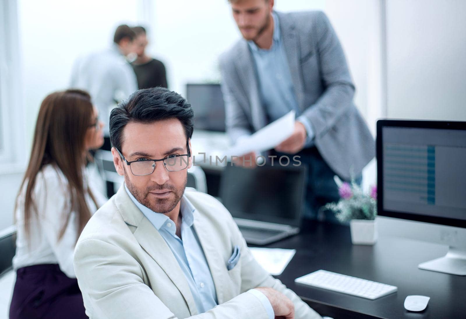 businessman sitting at the office Desk by asdf