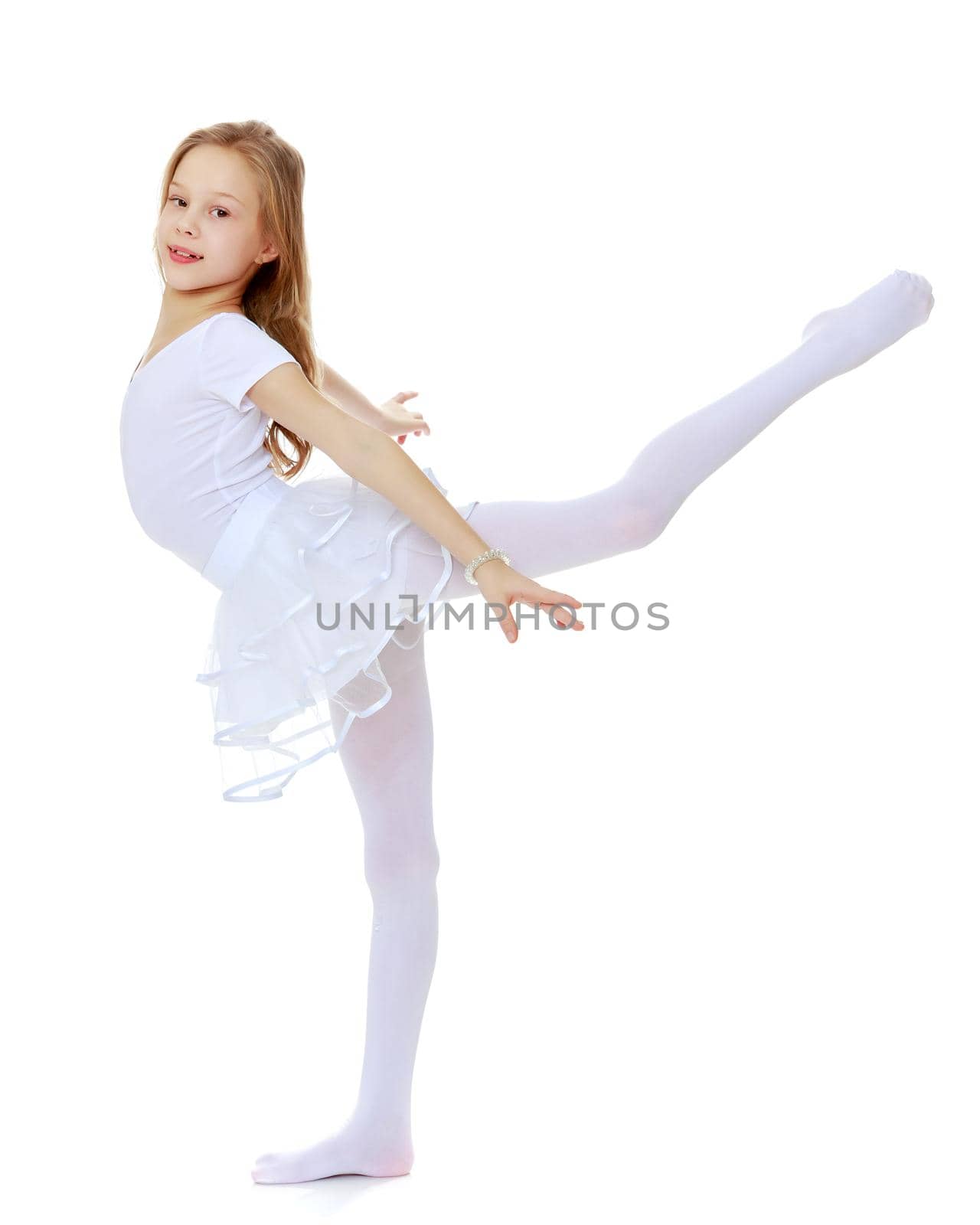 A girl gymnast balances on one leg.The concept of childhood, sport, a healthy lifestyle. Isolated on white background.