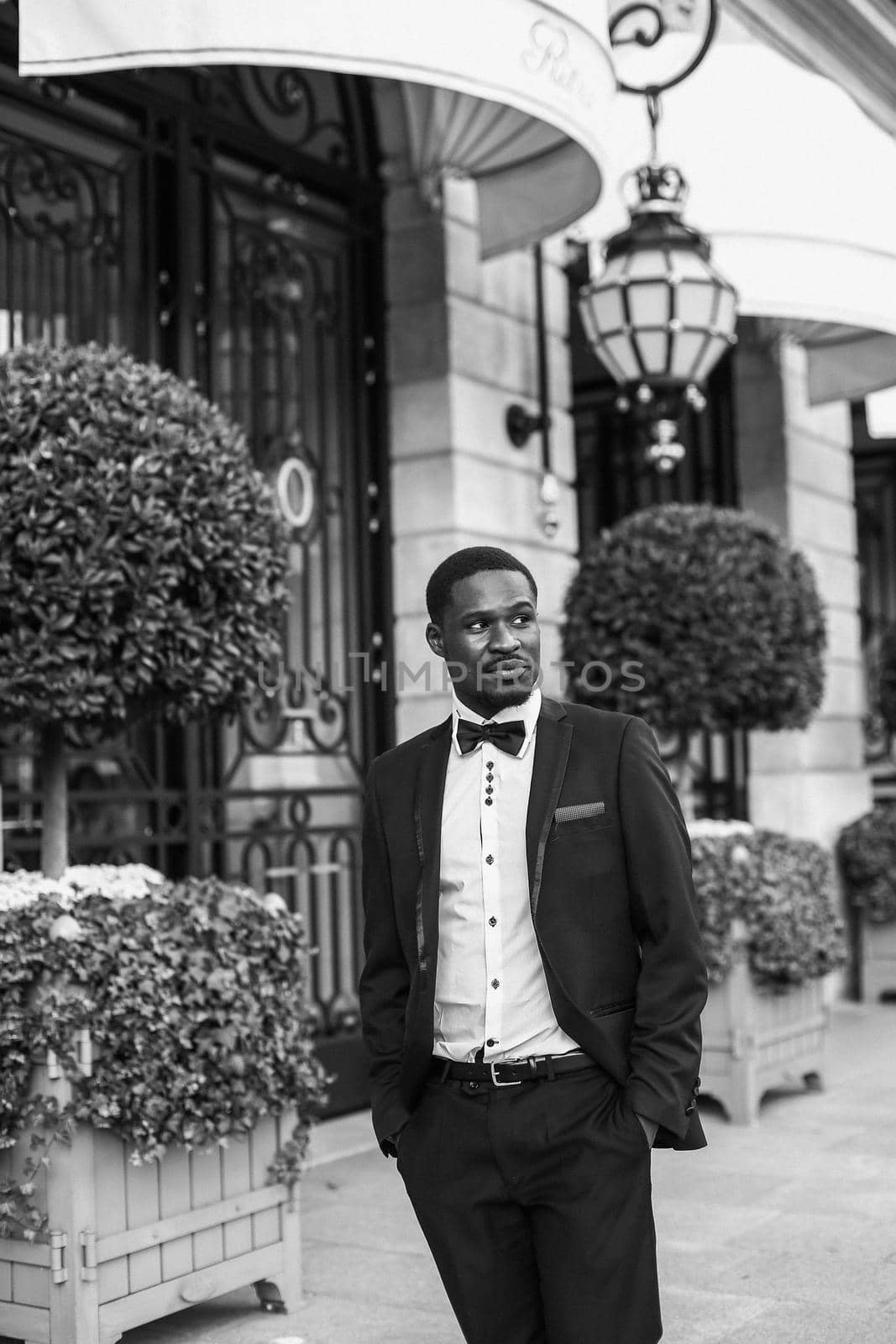 Black and white bw portrait Afro american handsome man wearing suit and smiling. in Paris by sisterspro