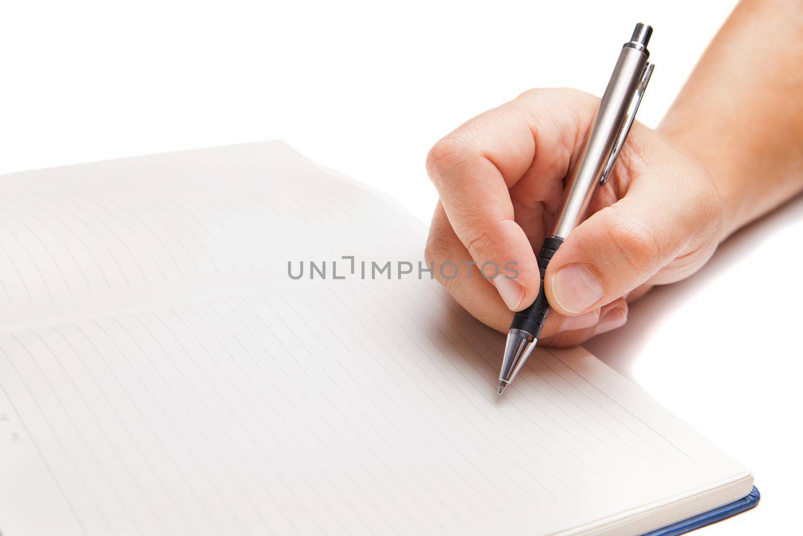 Man hand writing in open book isolated on white background