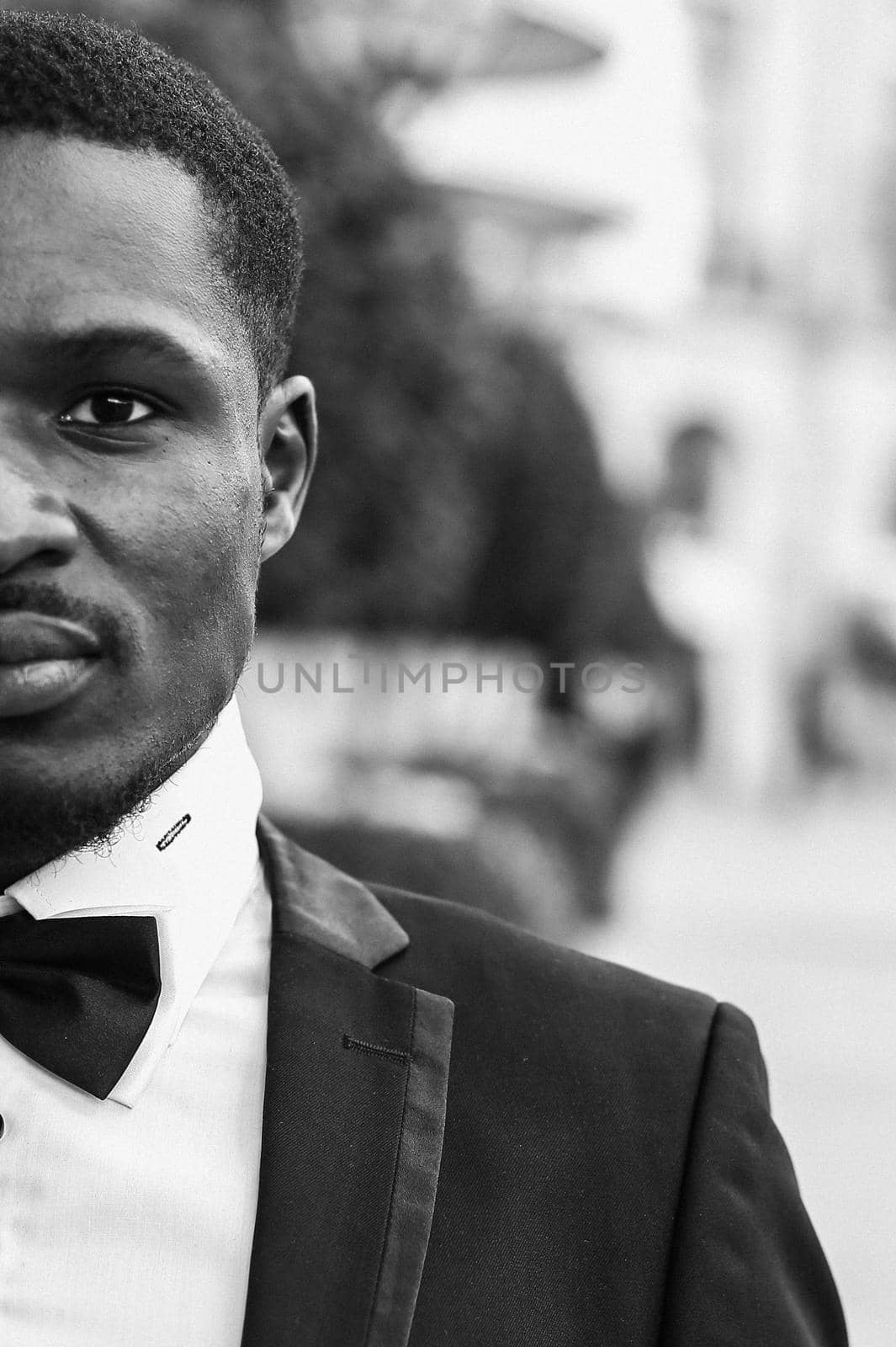 Black and white bw portrait of Afro american handsome man wearing suit and smiling. Concept of black businessman. in Paris