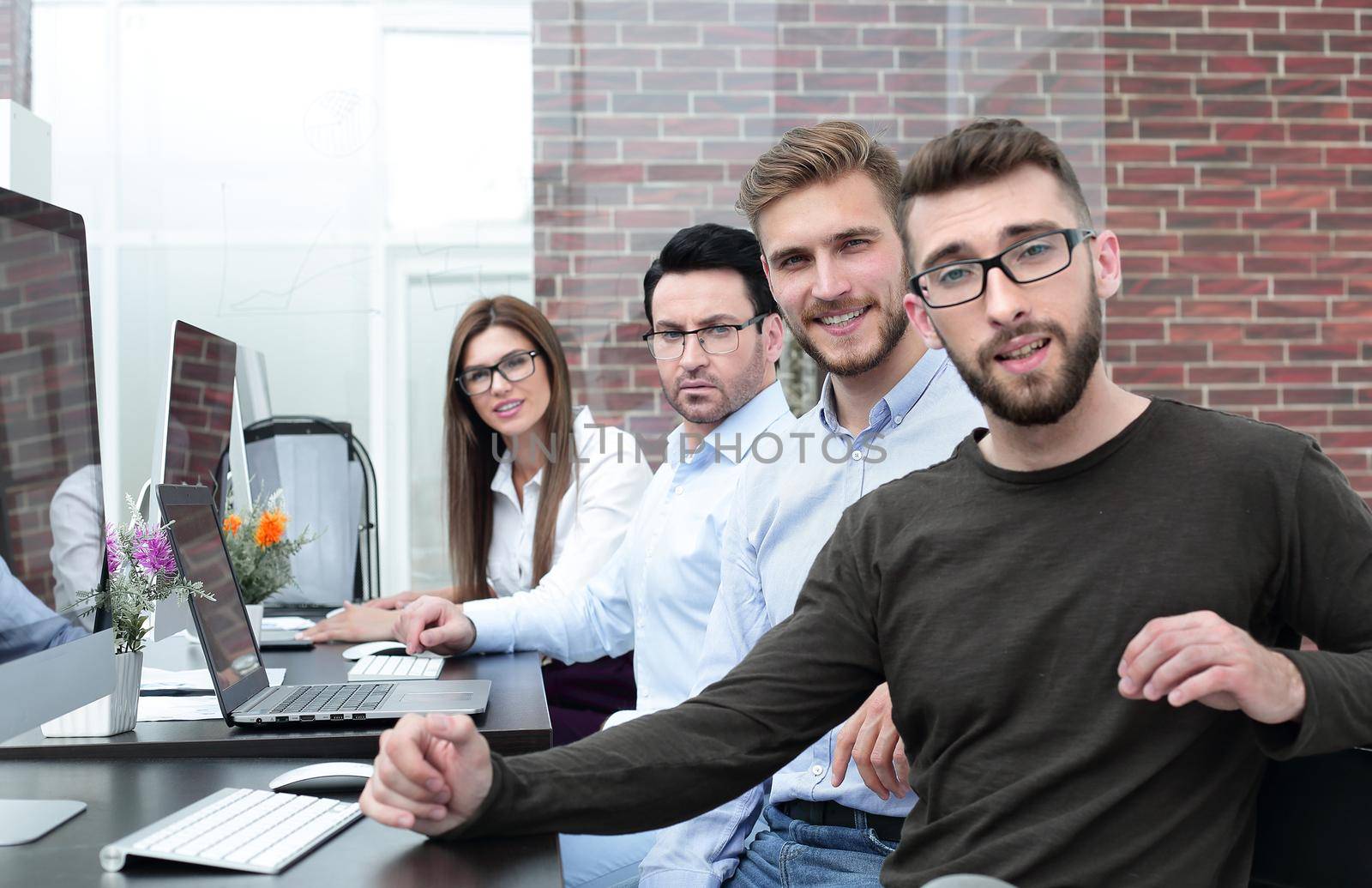 group of employees sitting at a Desk in a creative office.business concept