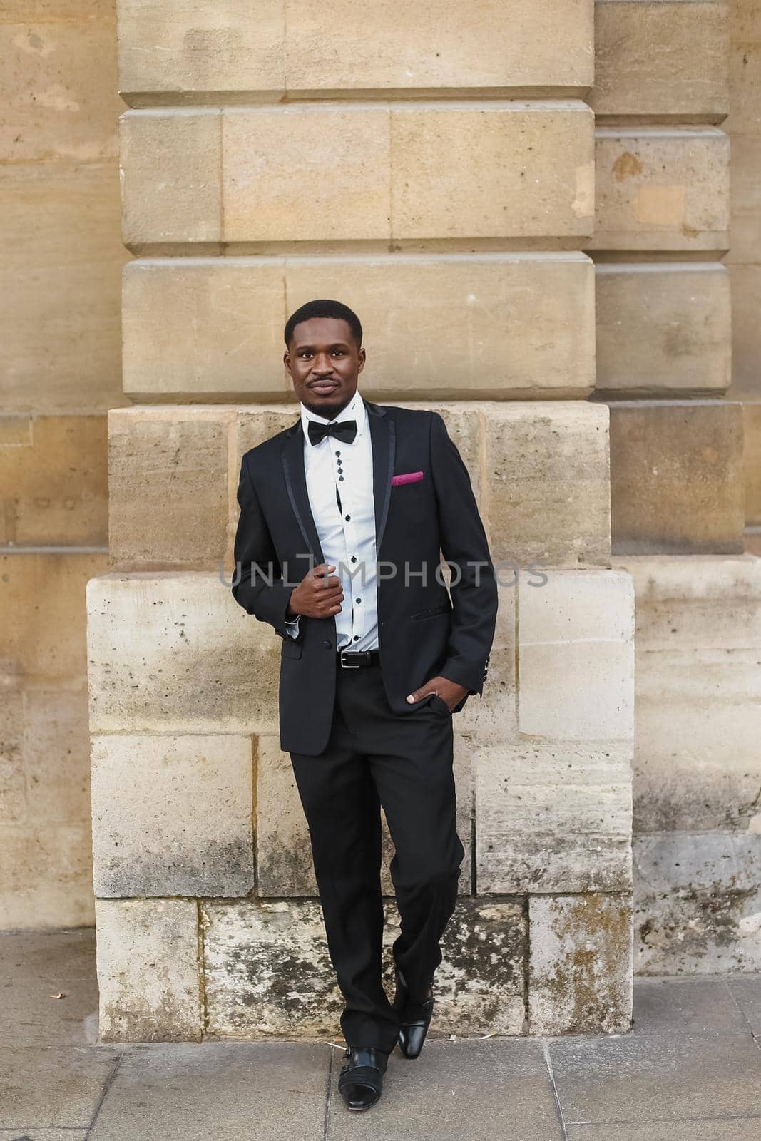 Afro american man wearing suit and standing outside. Concept of black businessman.