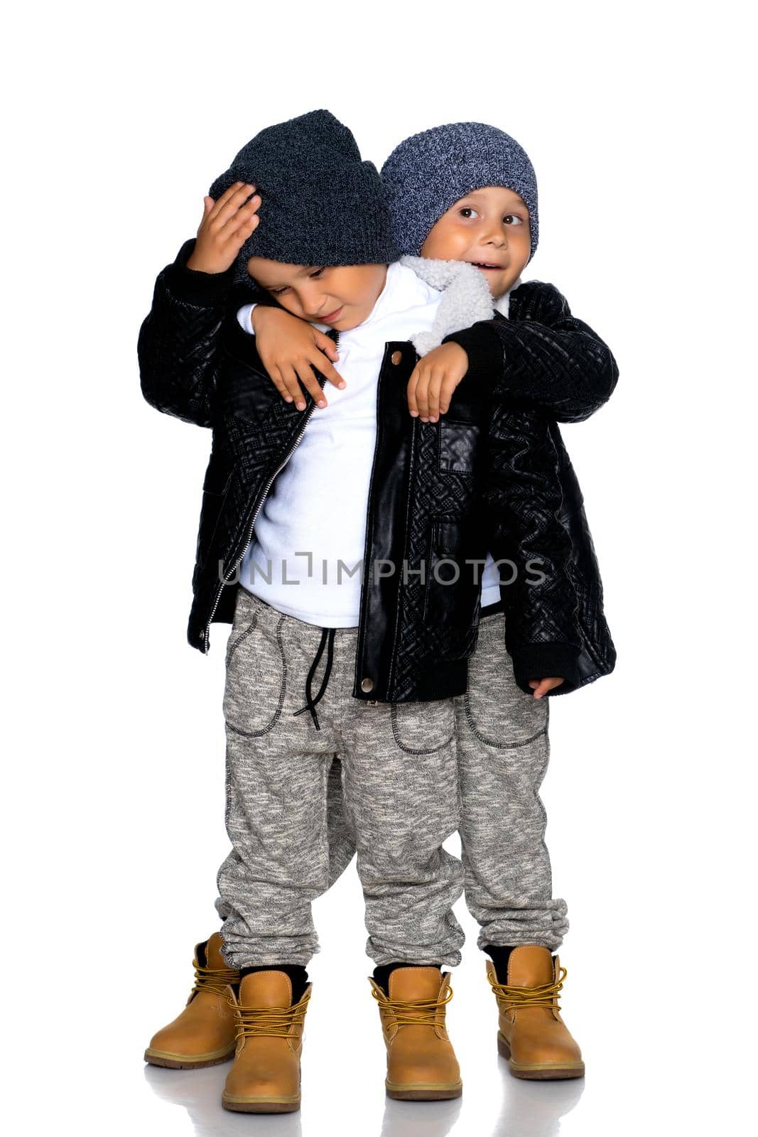 Two little boys in black jackets and hats. by kolesnikov_studio