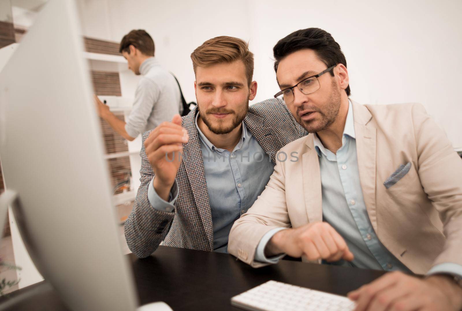 two businessmen look at the computer monitor.people and technology