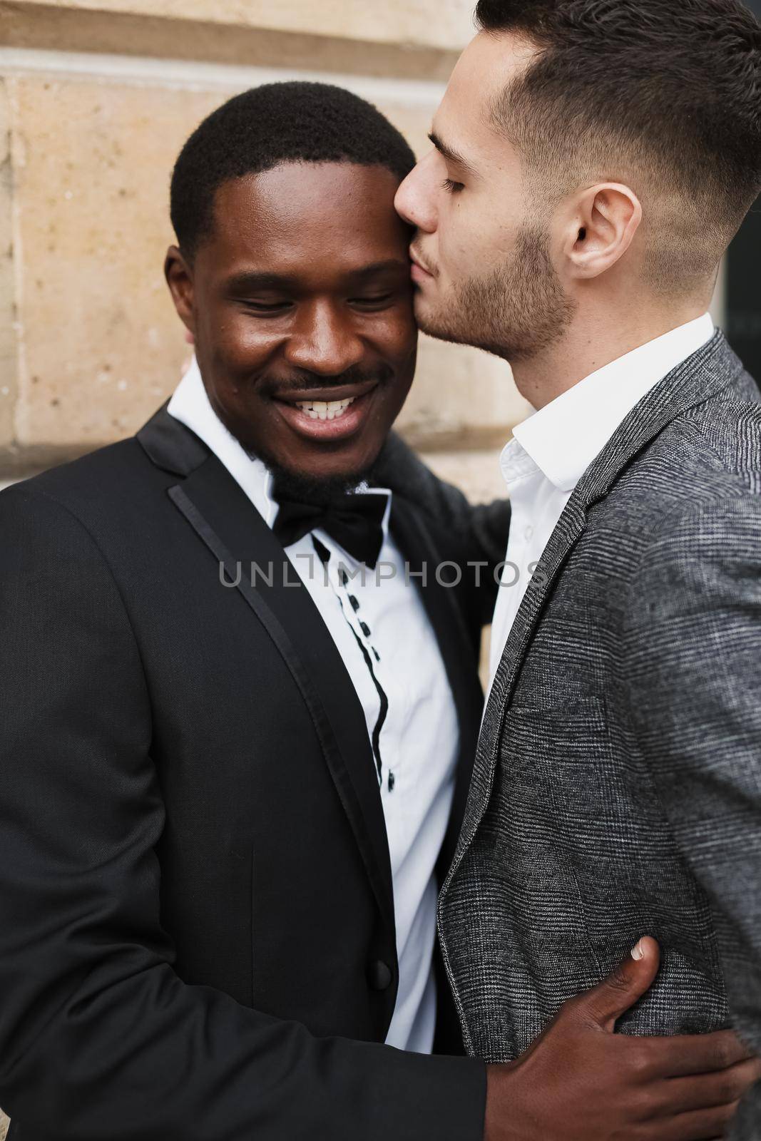 Afro american gay hugging european man outdoors. Concept of lgbt and same sex couple.