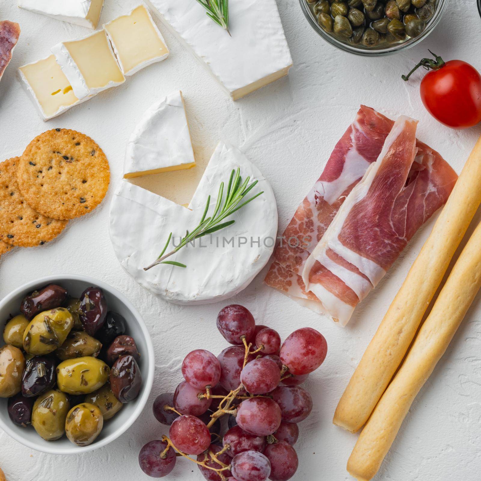 Assortment of cheese and meat appetizers set, on white background, flat lay