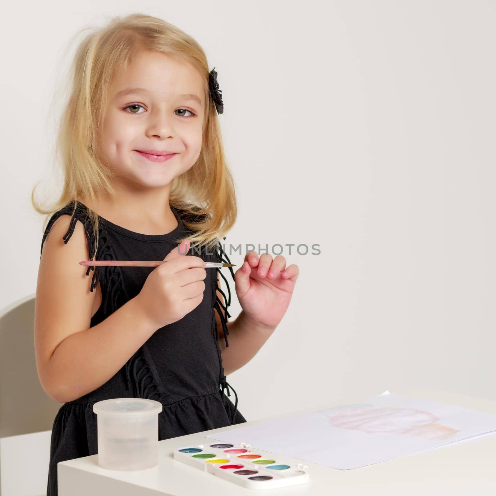 Little girl draws paints. by kolesnikov_studio