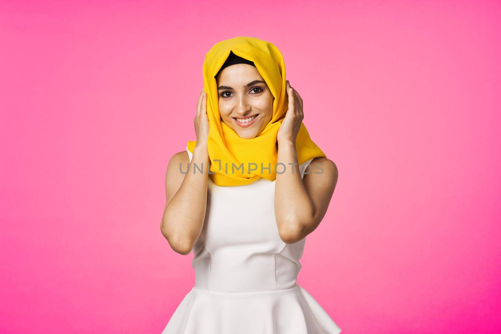 muslim woman in hijab posing fashion ethnicity pink background. High quality photo