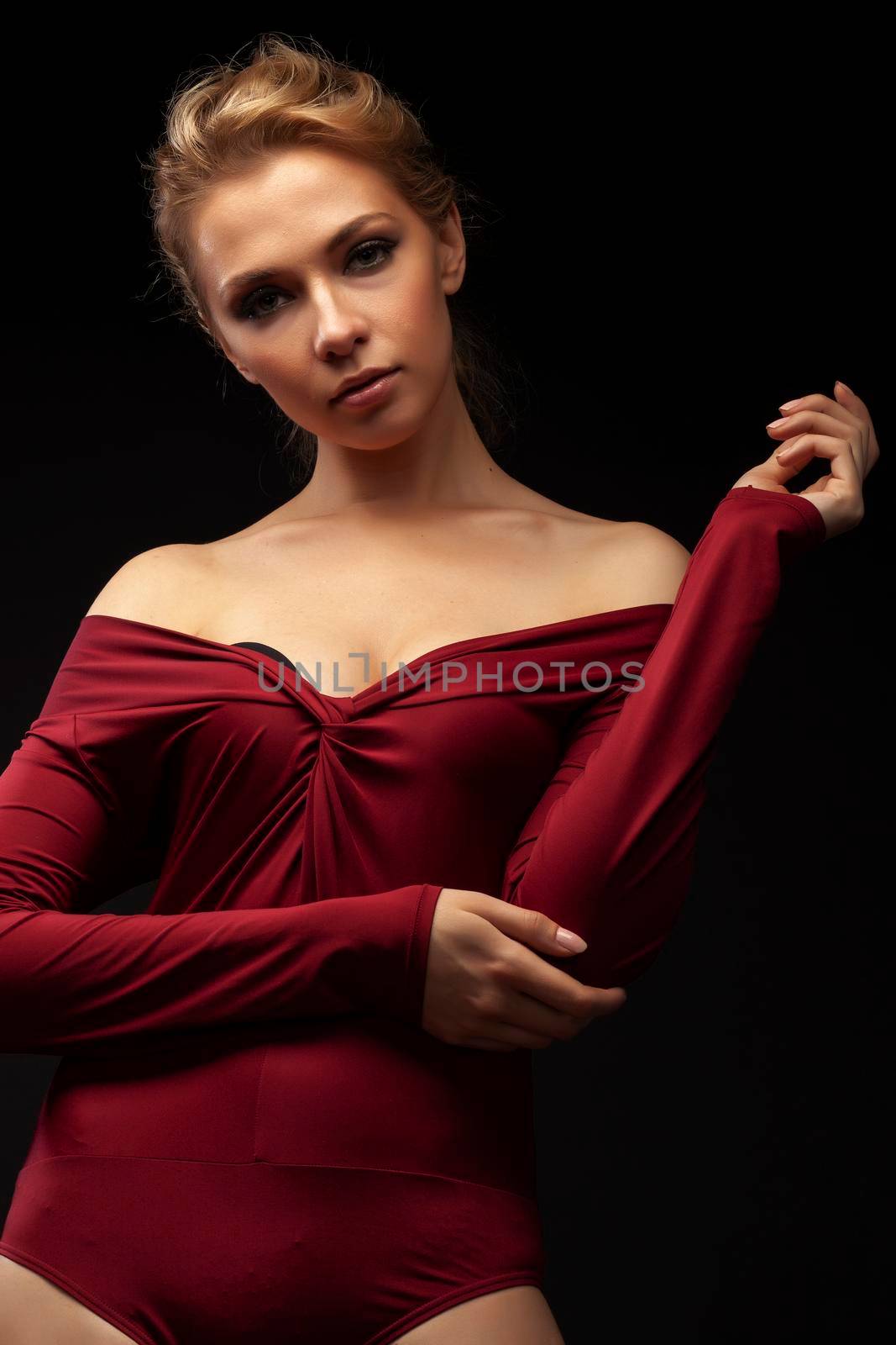 young sensual blond woman posing on black background, lifestyle people concept by JordanJ