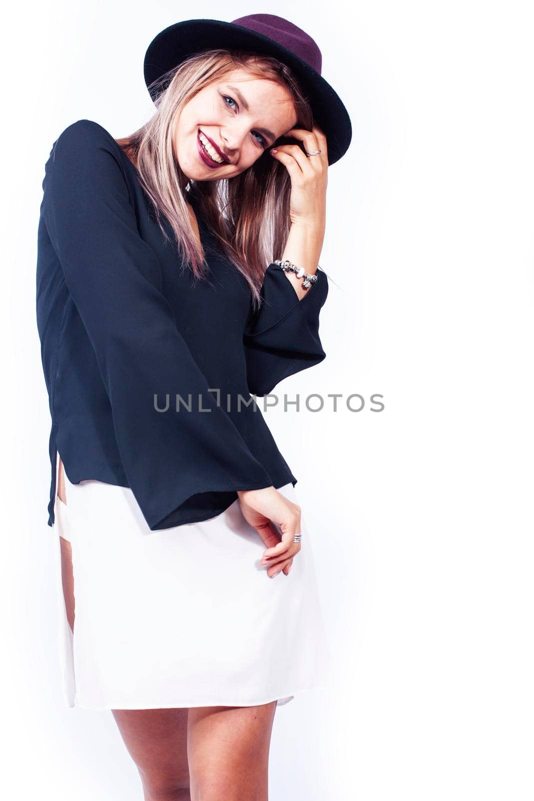 young pretty brunette girl hipster in hat on white background casual close up emotional posing smiling, lifestyle people concept