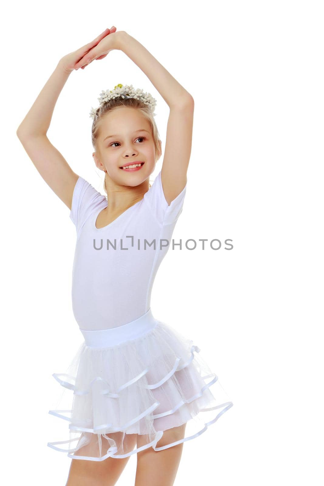 Little girl gymnast in a beautiful sports swimsuit for competitions, close-up. The concept of sport and fitness, a happy childhood. Isolated on white background.