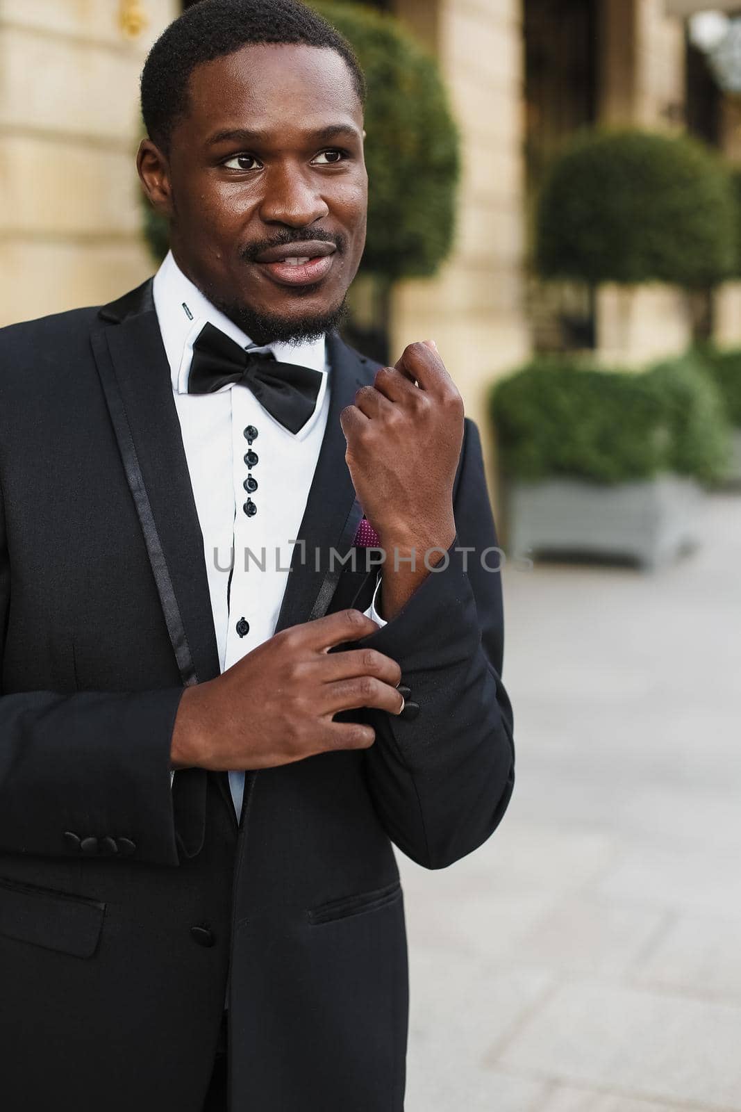 Afro american happy good looking man wearing suit and smiling outdoors. by sisterspro