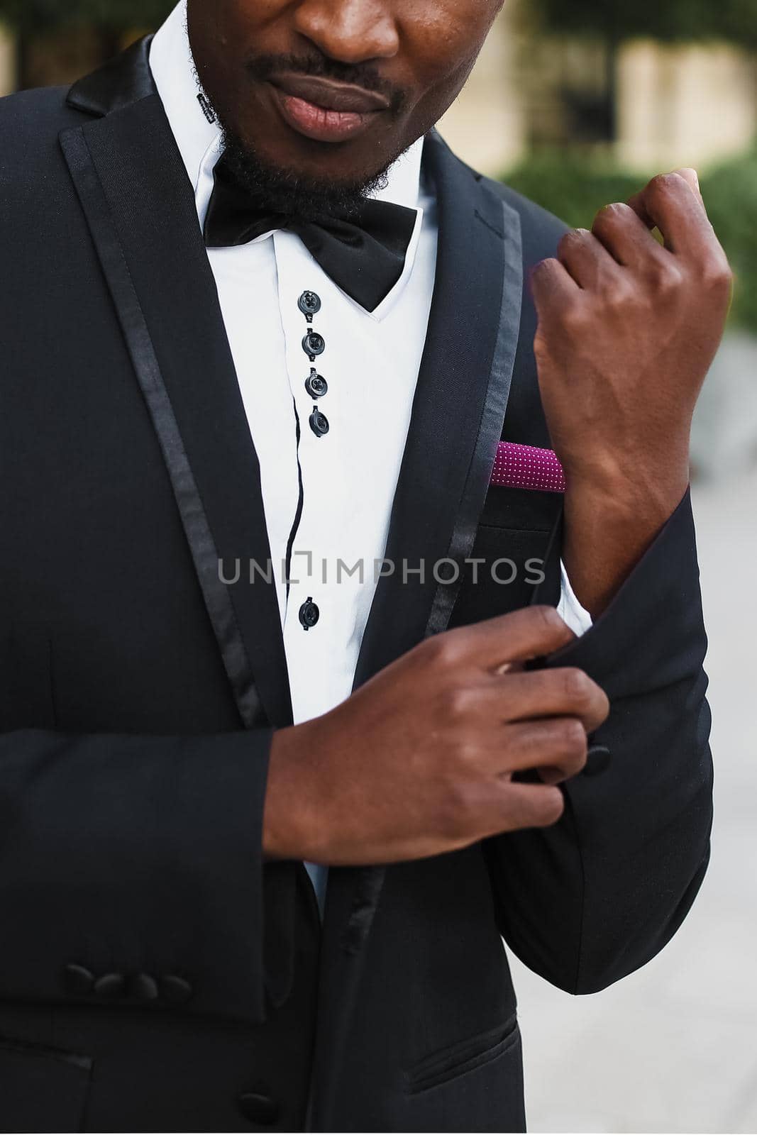 Afro american man wearing suit and standing near building. by sisterspro