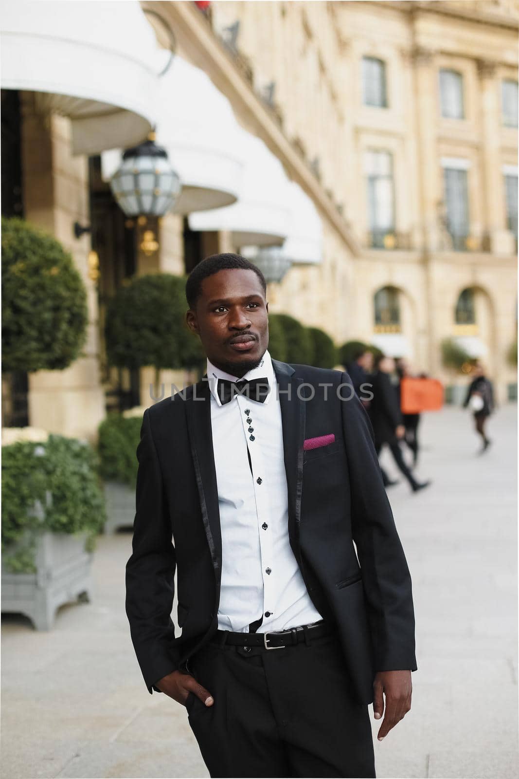 Afro american man wearing suit and standing outside. Concept of black businessman.