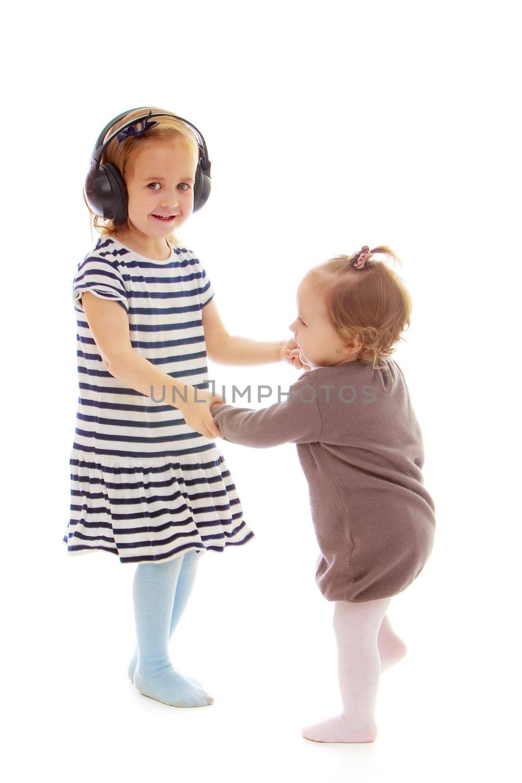 two sisters play fun playing. The concept of family happiness and development of children. Isolated over white background