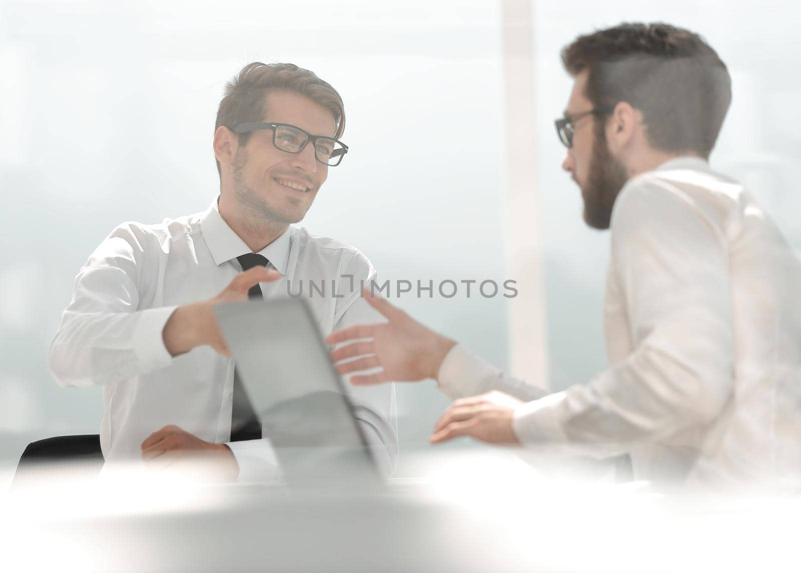 two employees greet each other at the Desk.photo with copy space