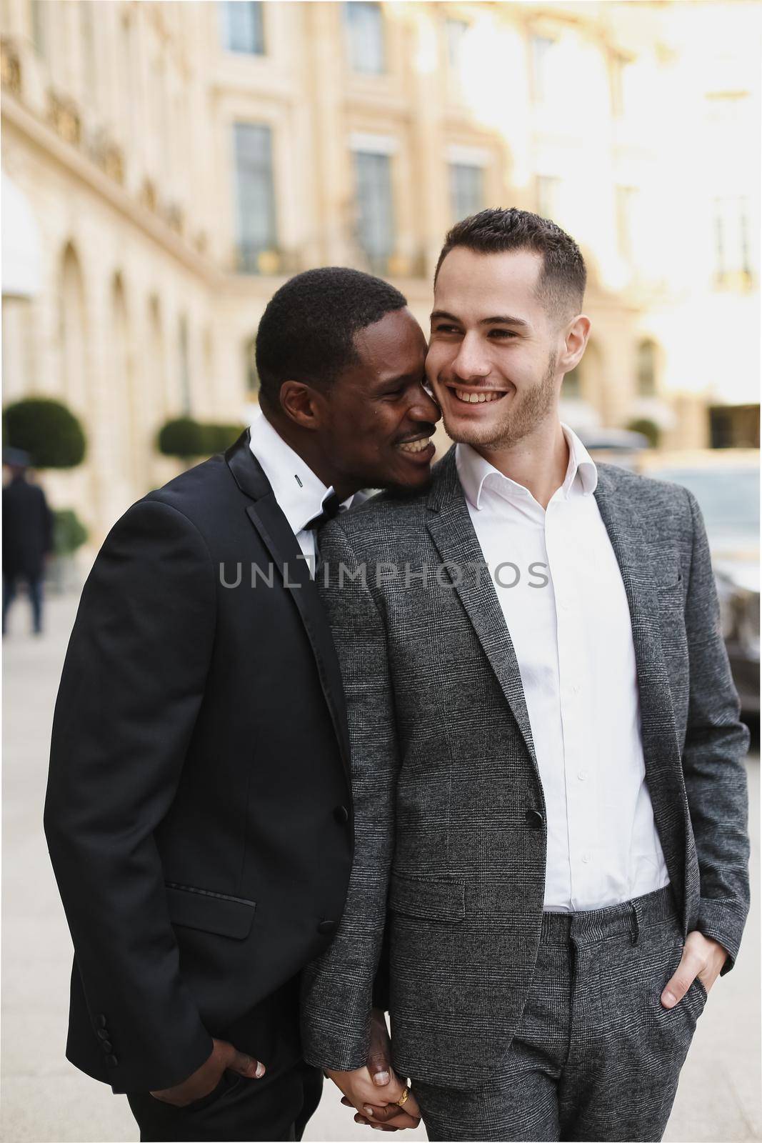 Afro american and caucasian stylish gays walking outside. by sisterspro