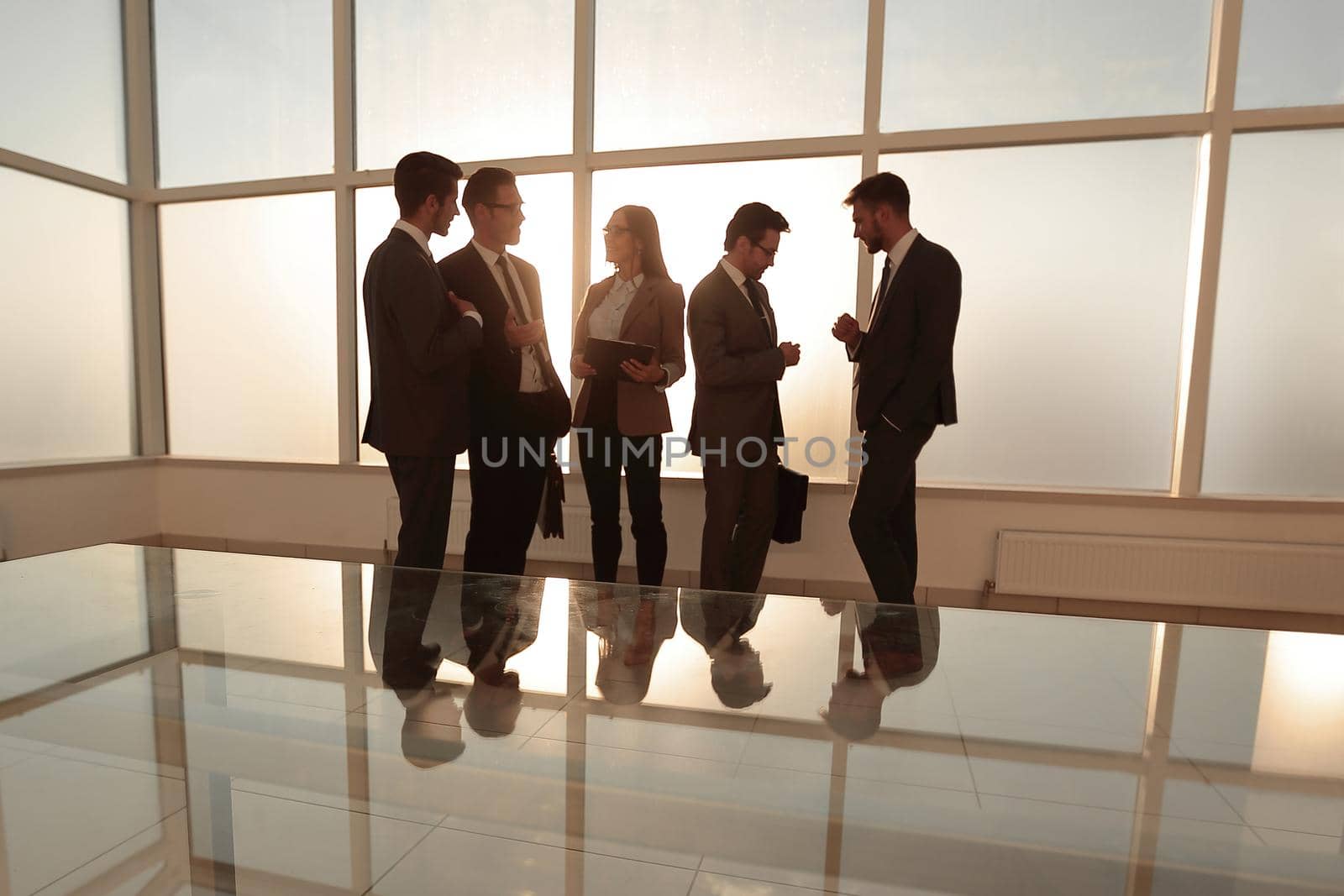 photos of businessmen in a conference room with morning light.