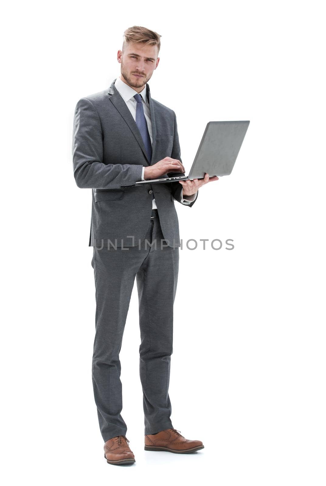 in full growth, a businessman with an open laptop.isolated on white background