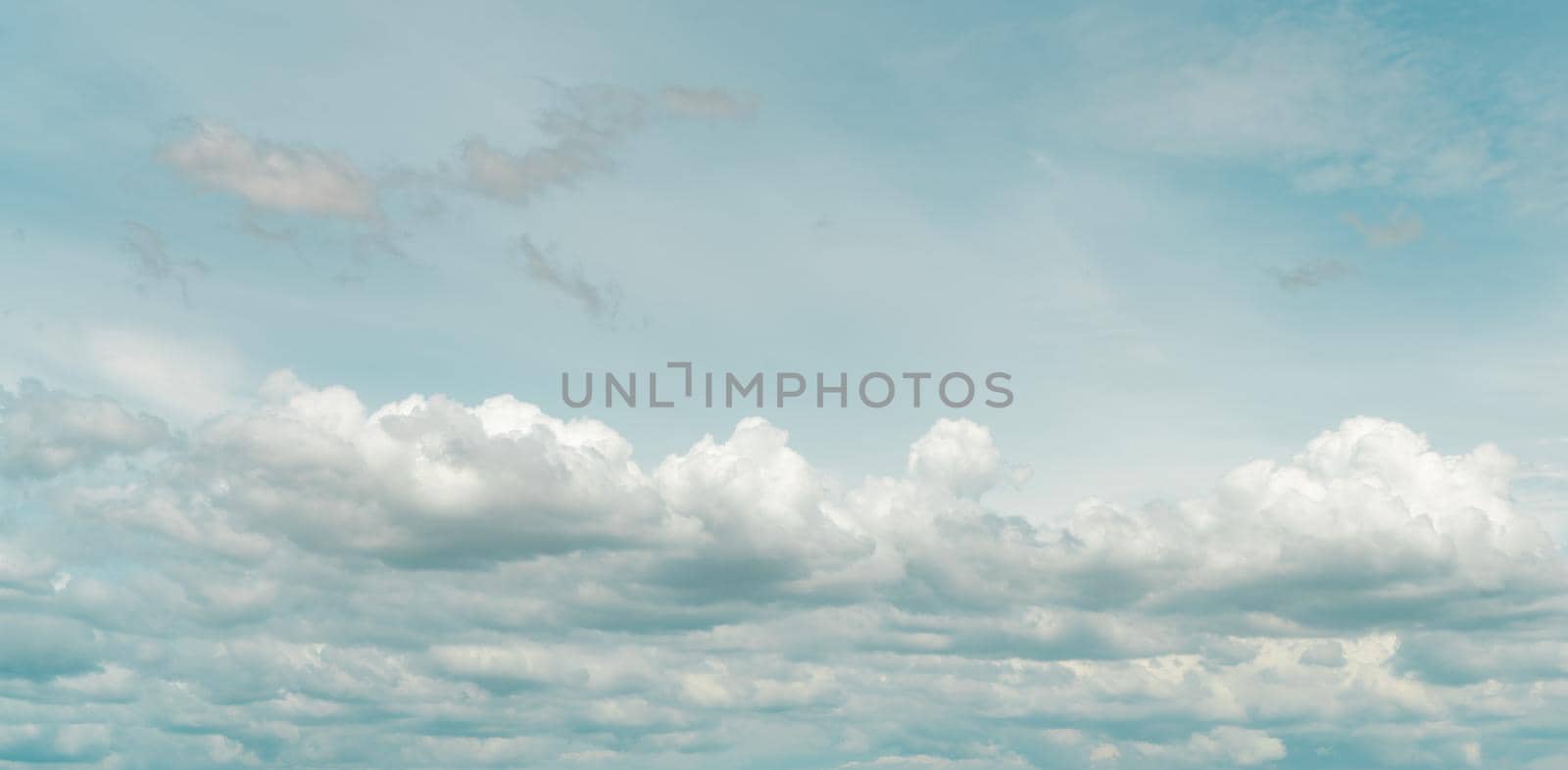 Panorama view of white fluffy clouds on blue sky. Close-up white cumulus clouds texture background. White puffy cloudscape. Beauty in nature. Soft-touch feeling like cotton. Beautiful cloudscape. by Fahroni