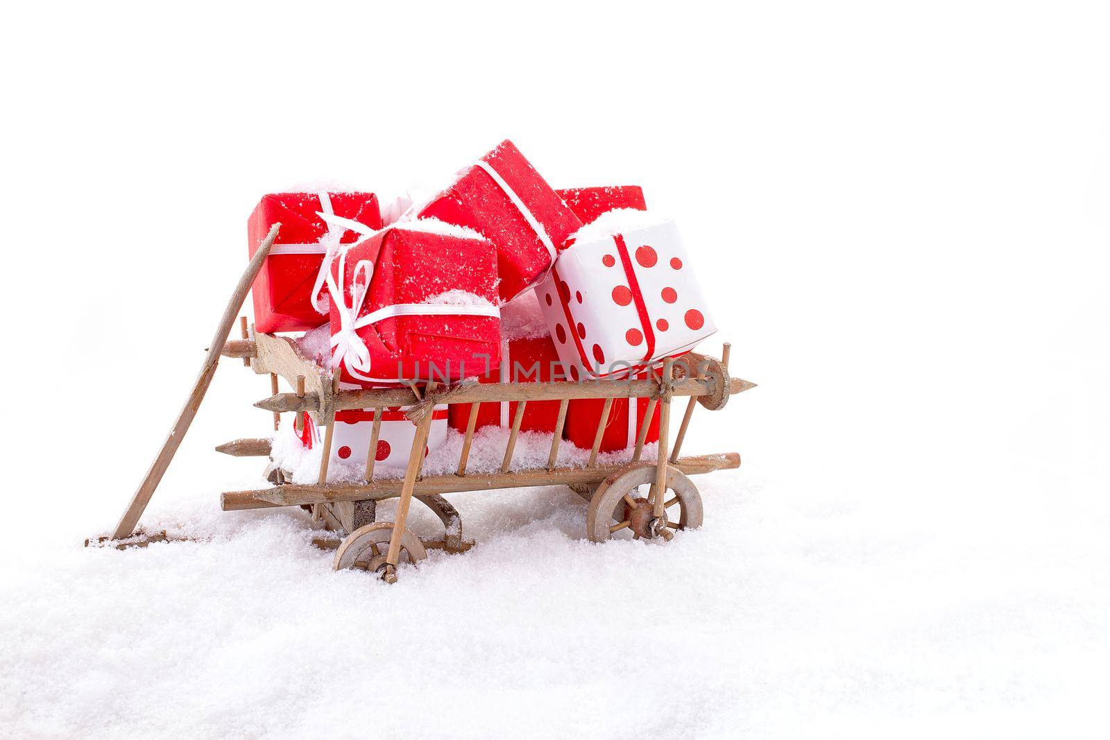 Wooden cart full of presents in the snow